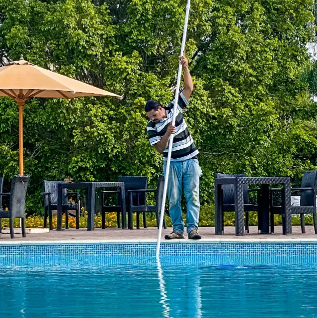 A man servicing a swimming pool.